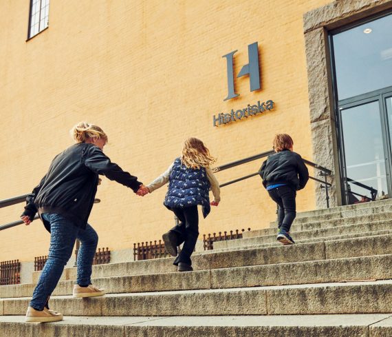 Adult and children walking up the steps of the Swedish History Museum.