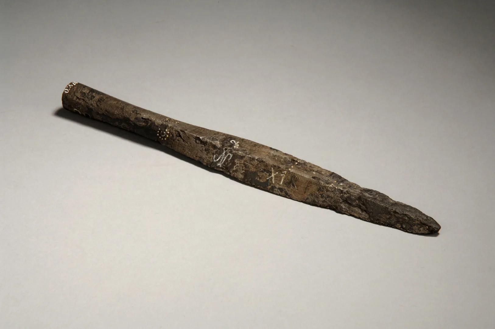A spear's head of metal, inscribed with runes.
