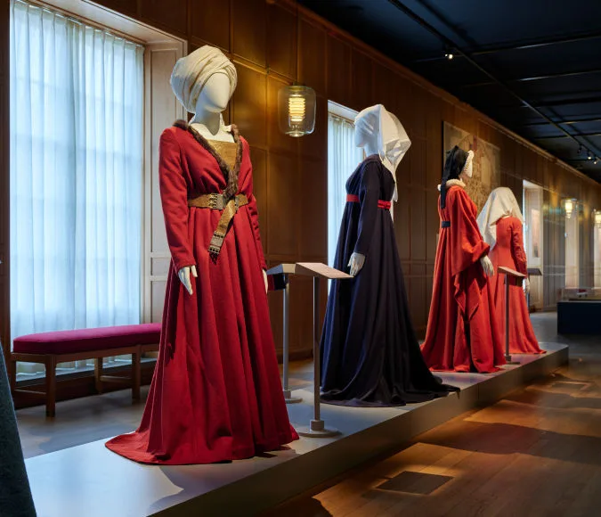Mannequins dressed in clothing displayed in the Medieval Fashion exhibition.