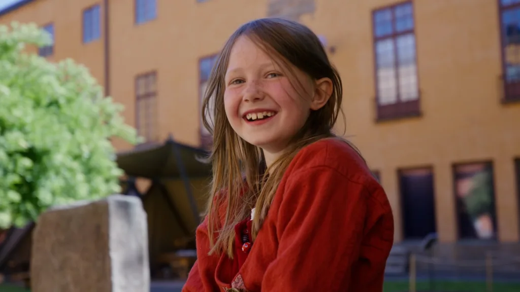 Children playing in the courtyard of the museum on a sunny day.