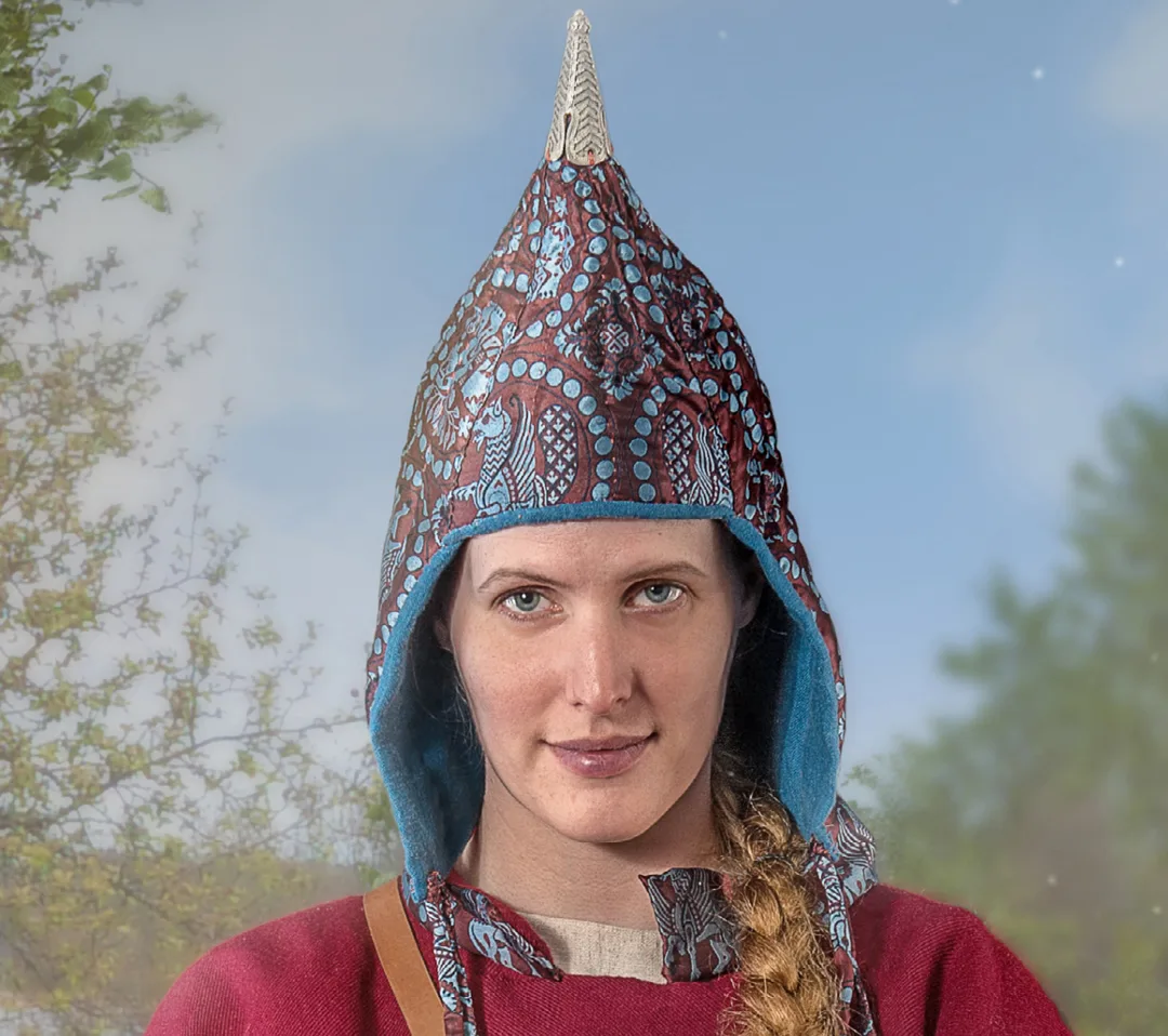 Person wearing a traditional hat with silver hat decoration