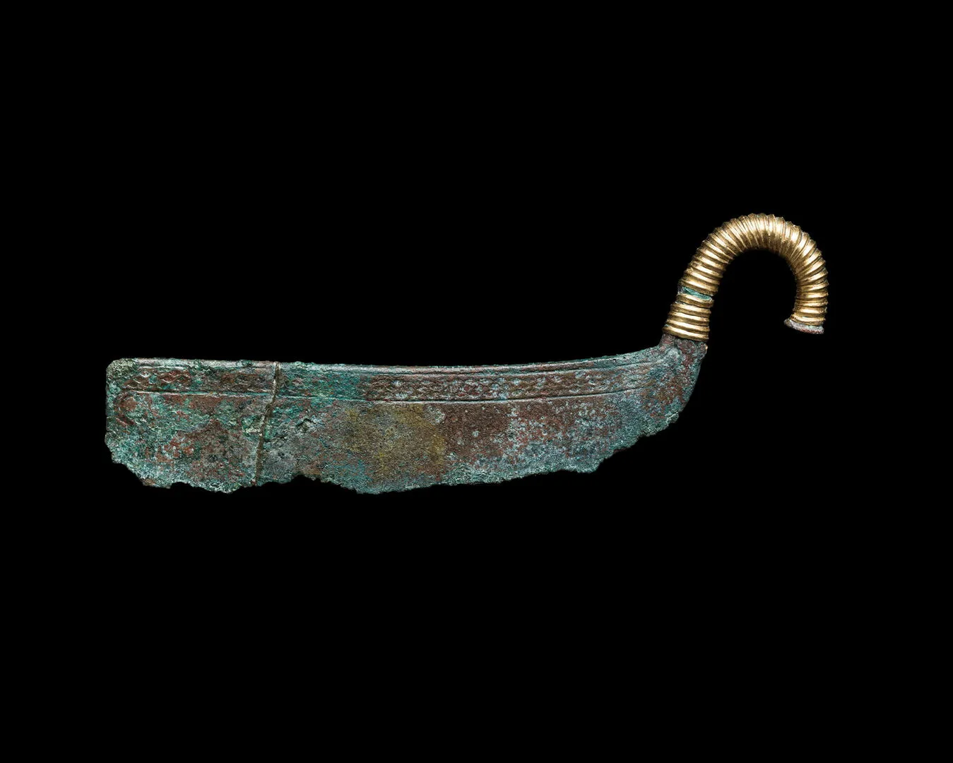 A bronze razor with a curved gold handle.