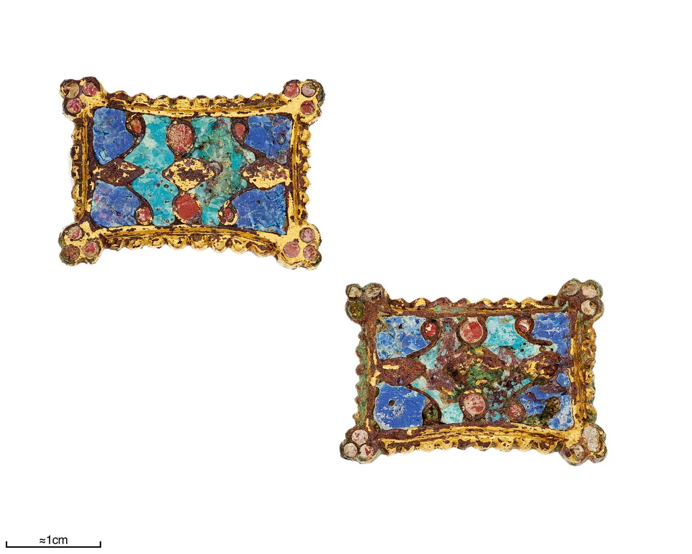 Two brooches of blue, red and green enamel surrounded by gilt metal.