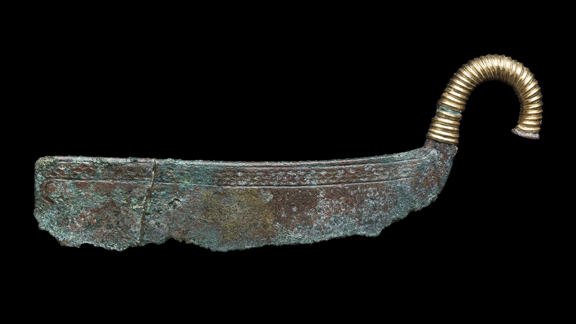 A bronze razor with a curved gilt handle