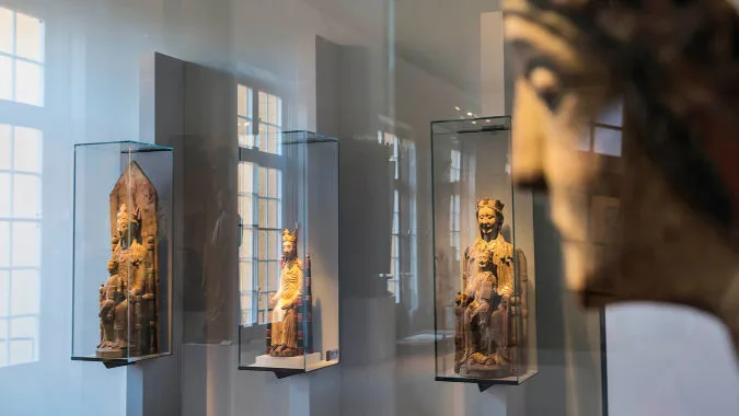 Display cases with sculptures inside.