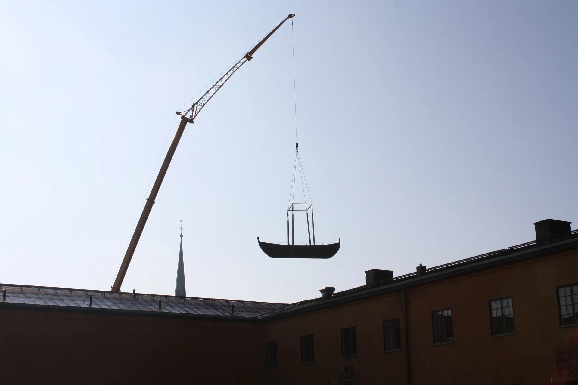 A crane is lifting a boat.