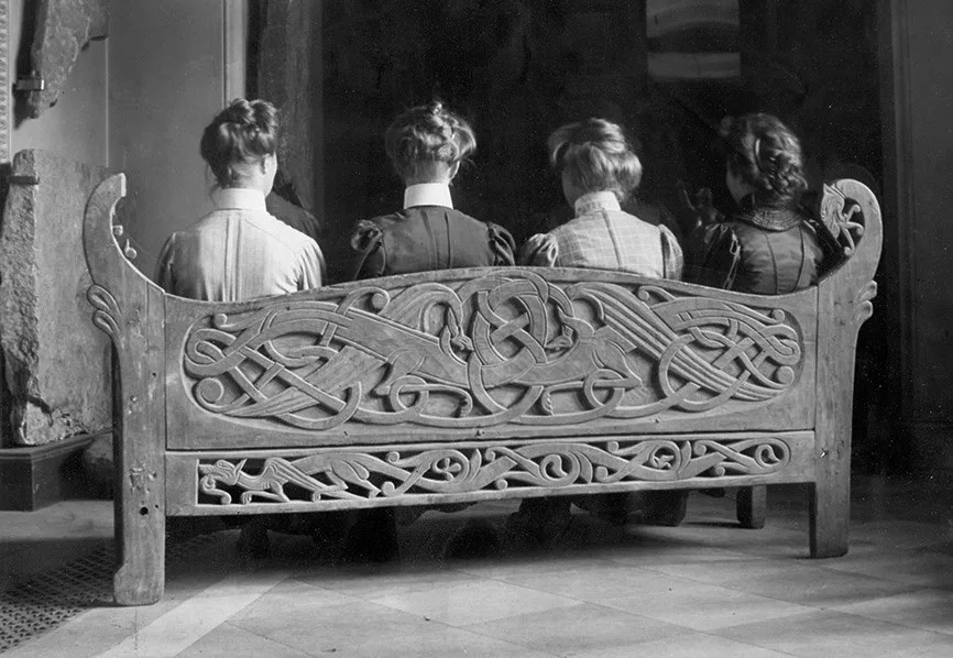 Archival photo of four women sitting on a bench