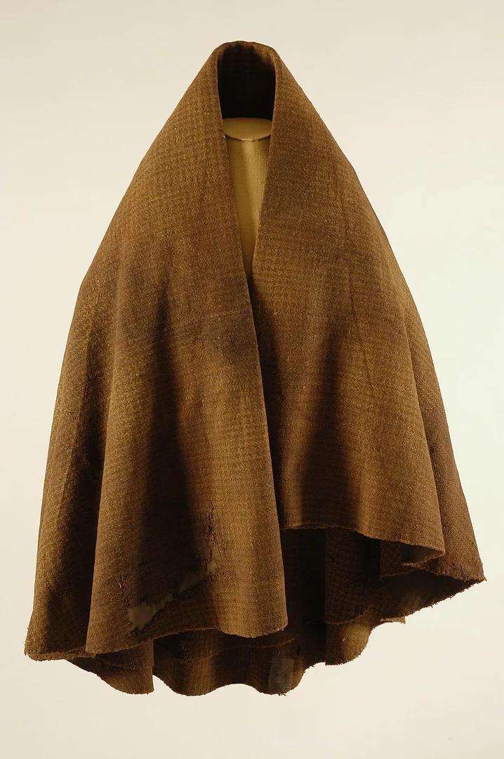 A brown cloak hanging on a dummy