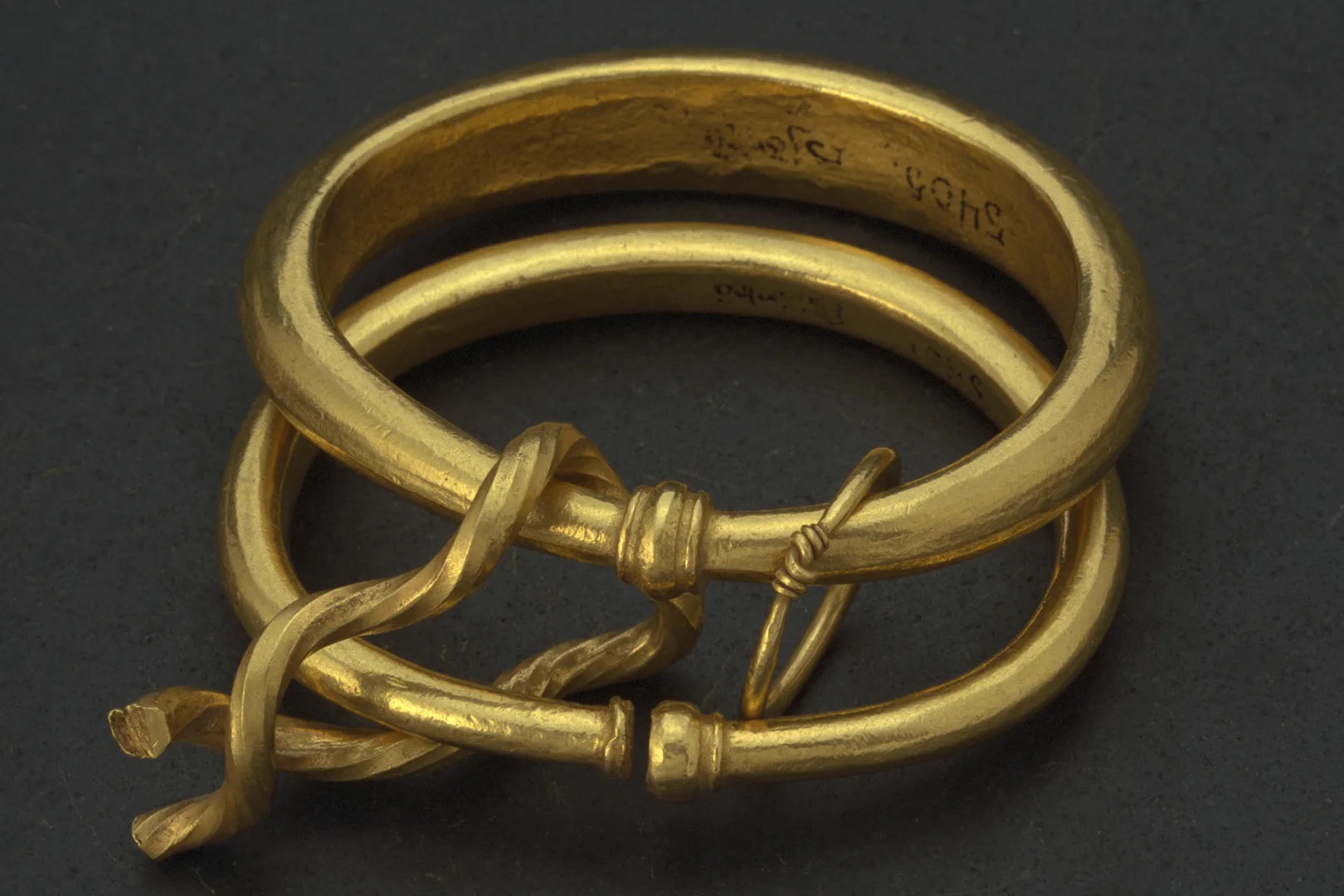 Two gold rings linked together