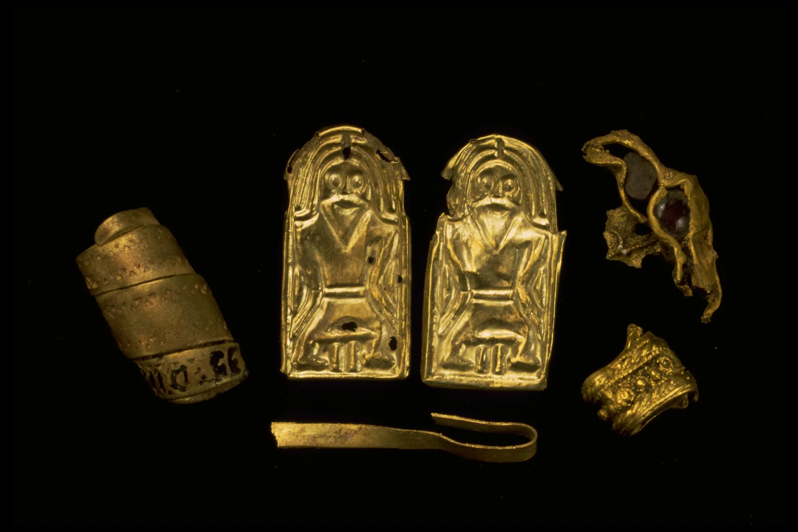 Gold foil figures depiciting a man with a beard