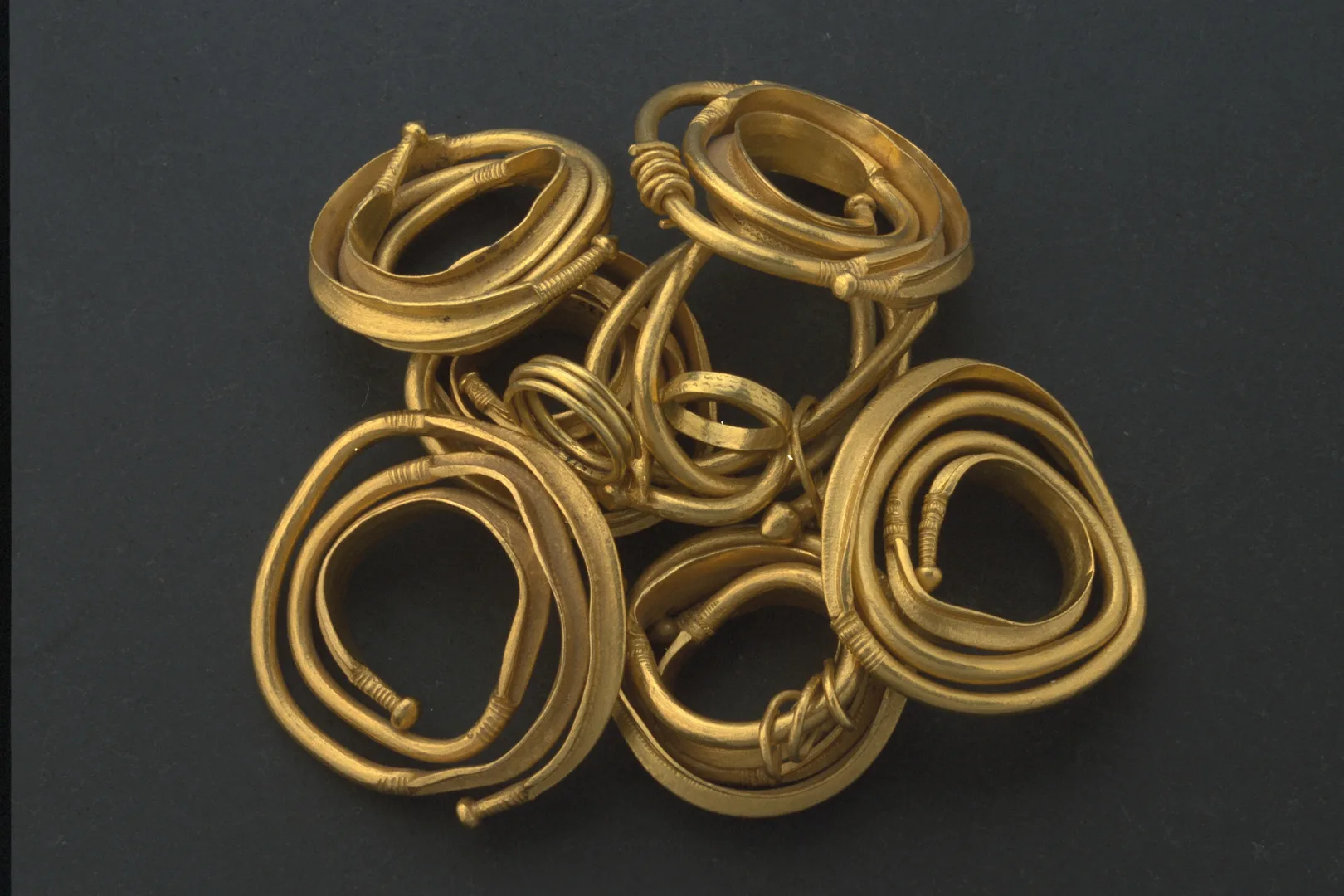 Several large gold rings and bracelets.