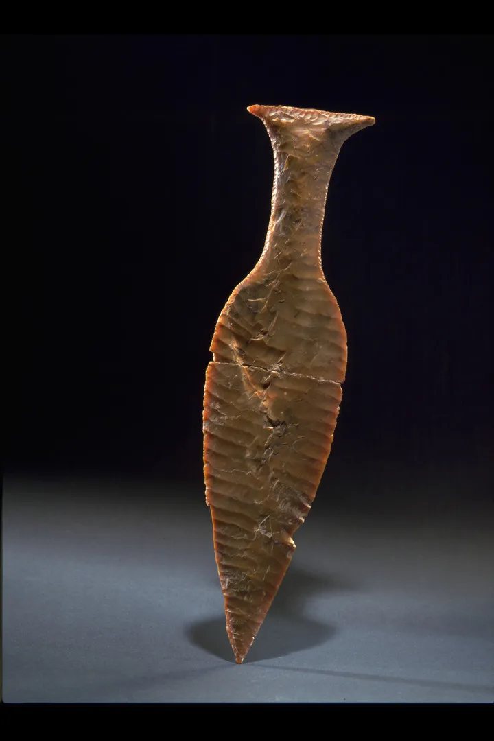 A reddish brown flint dagger 