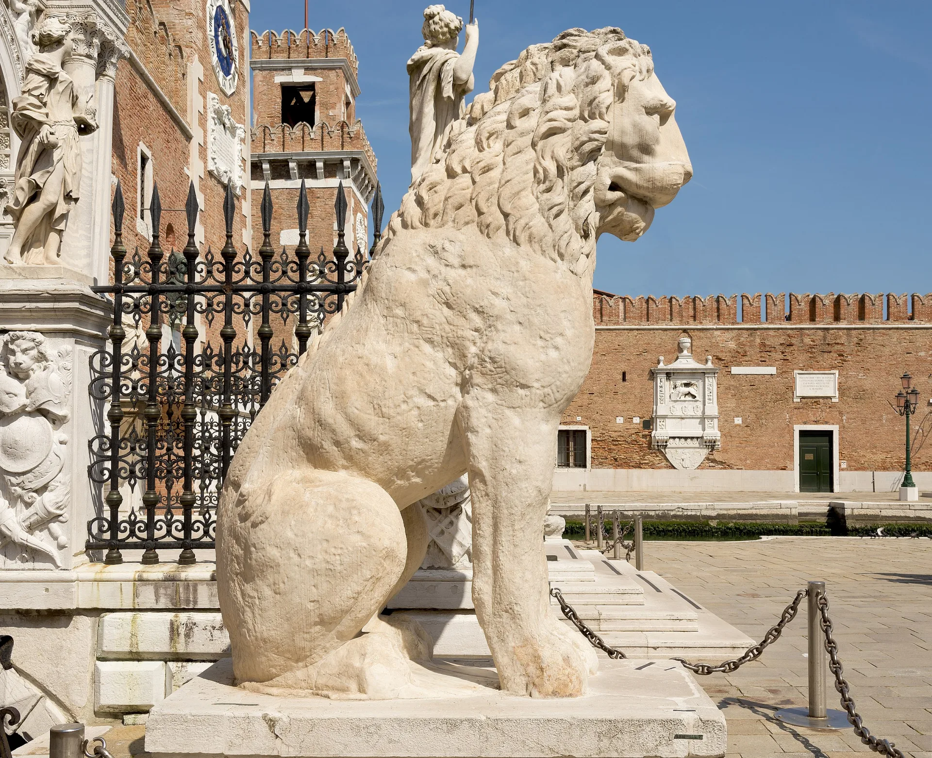 A sculpture of pale yellow stone depicting a lion. 