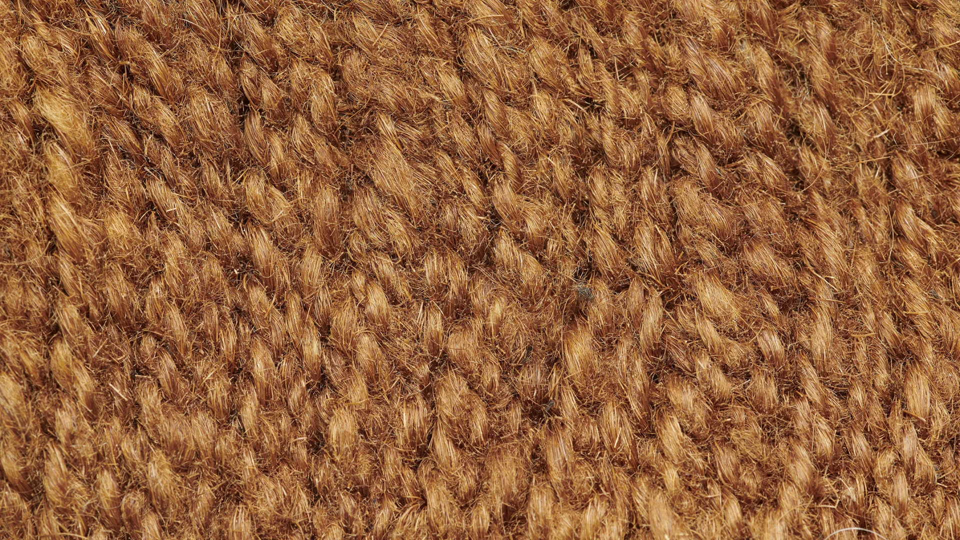 Close-up of a knitted, yellowish-brown surface.