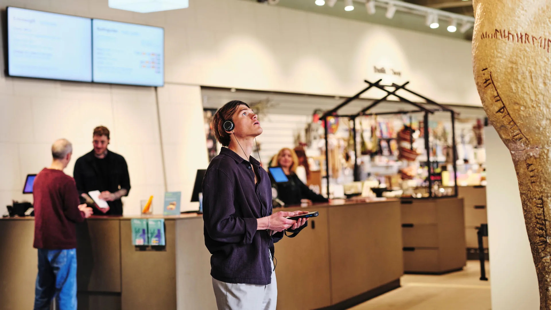 A visitor exploring the museum while listening to an audio guide.
