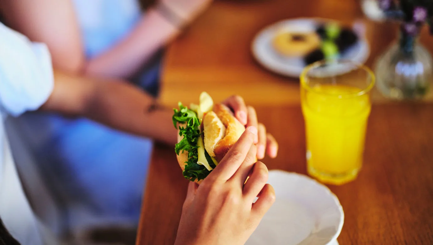 A child eating a sandwich during a lunch break.
