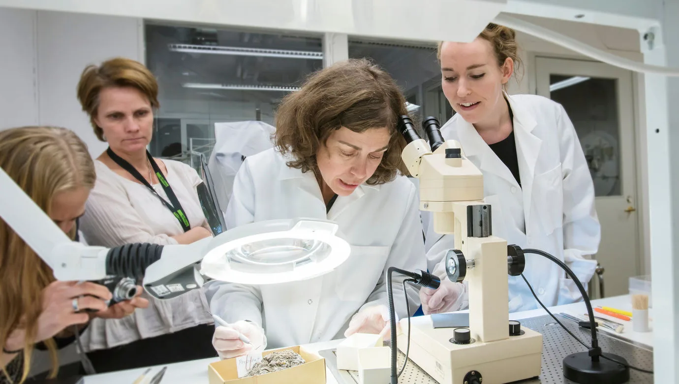 Three people in white lab coats