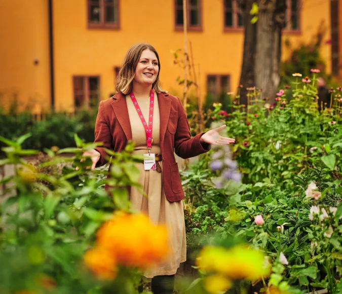 Museum staff standing outside the museum among greenery