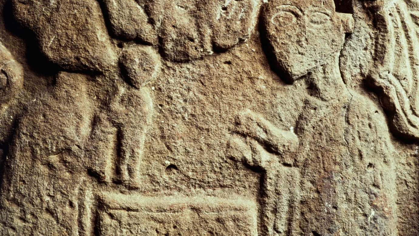 Stone fresco depicting a child being baptized