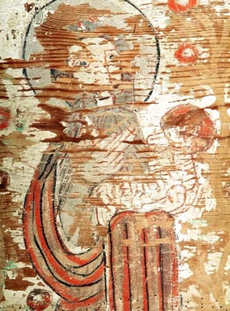 A very worn painting of a man holding a child.