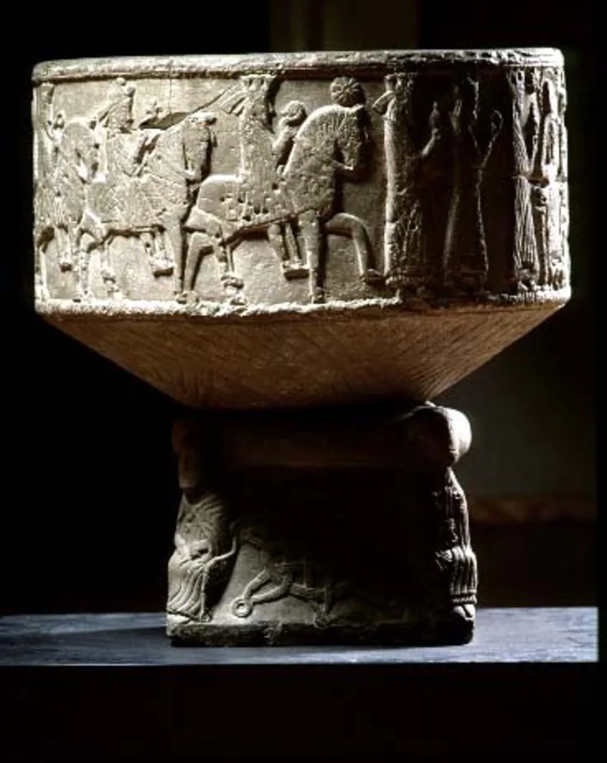 Dopfunt eller stenbassäng på fot, med inhuggna figurer 