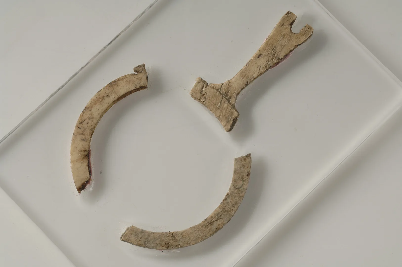 Parts of a circular objects that once held a piece of glass.