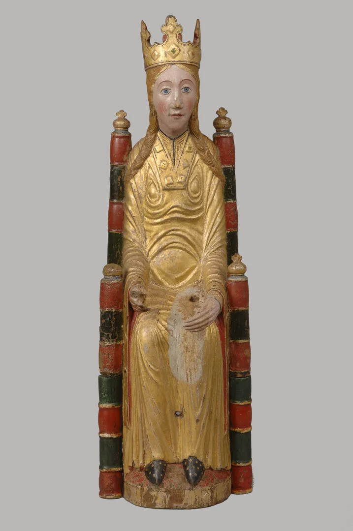 A woman in golden robes wearing a crown  sitting on a throne.