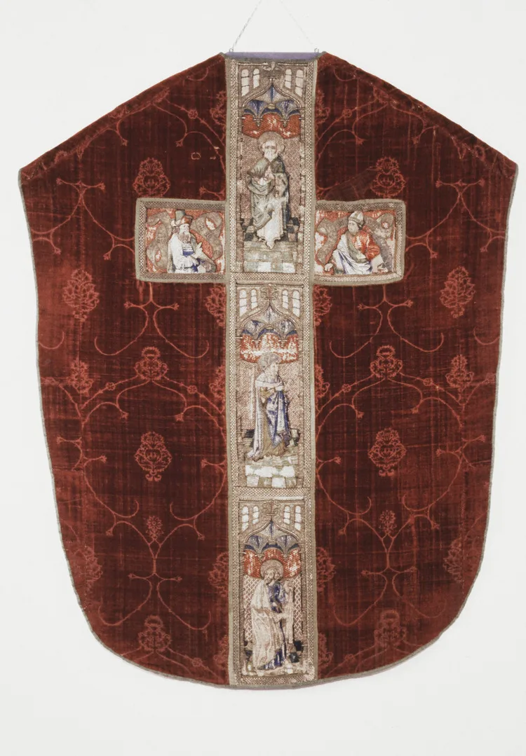 A red silk cloak with an embroidered cross.
