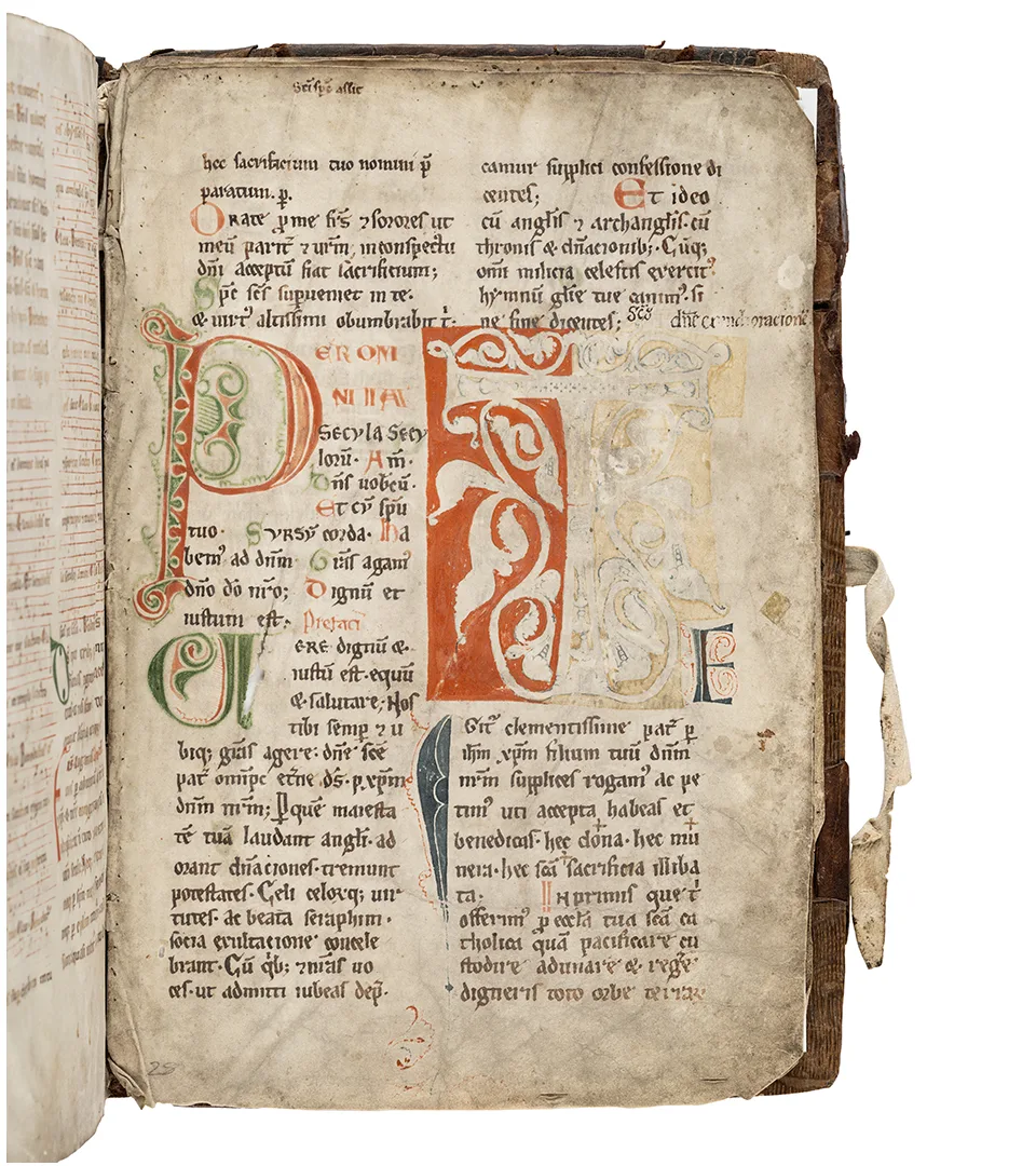 A page from an old book with closely written text and illuminated initials.