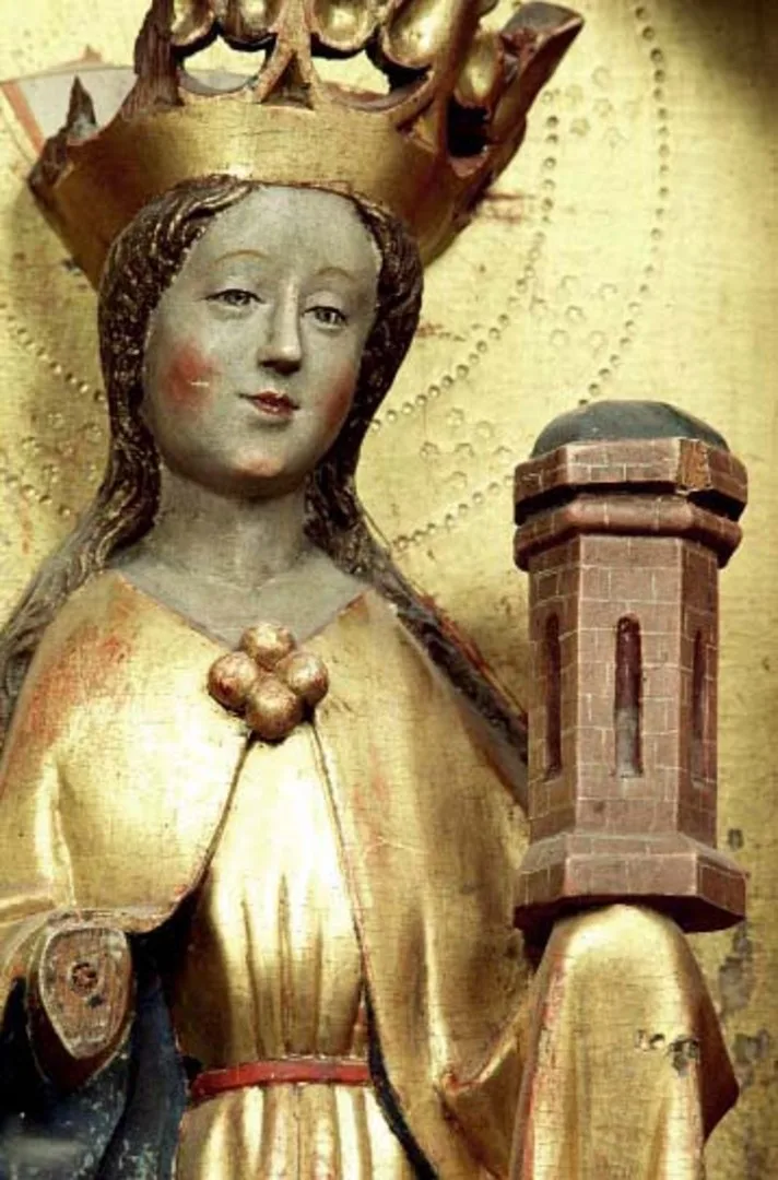 Wooden sculpture of a women holding a miniature tower