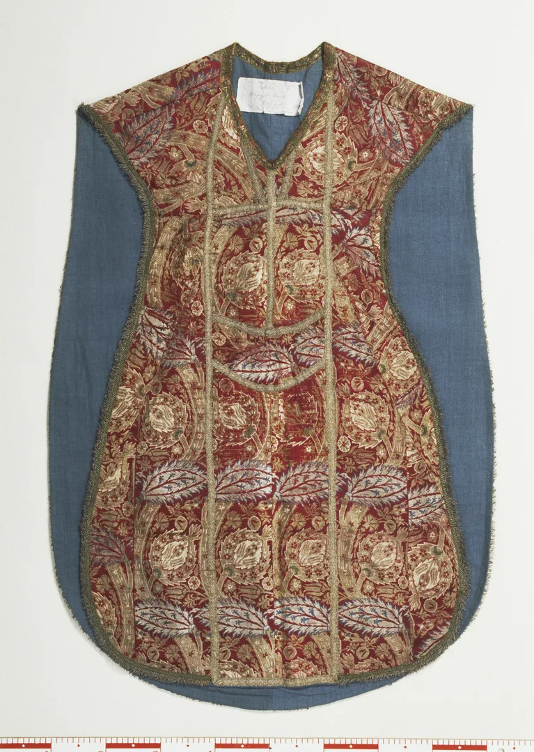 A patterned chasuble decorated with red, silver and gold