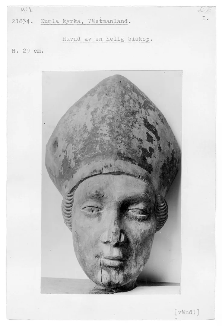 An index card with an old photograph showing the object.