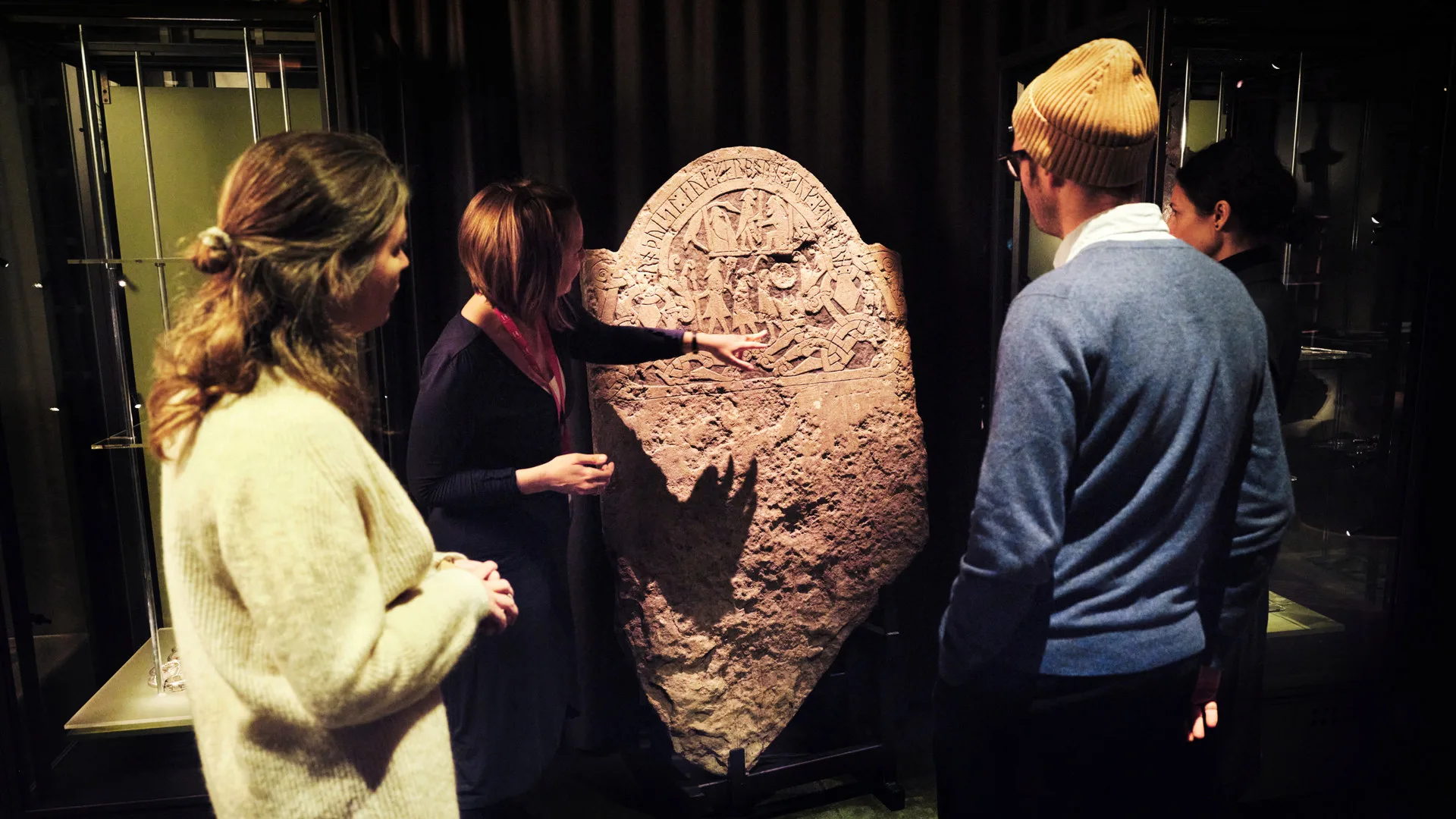 People standing in front of a picture stone