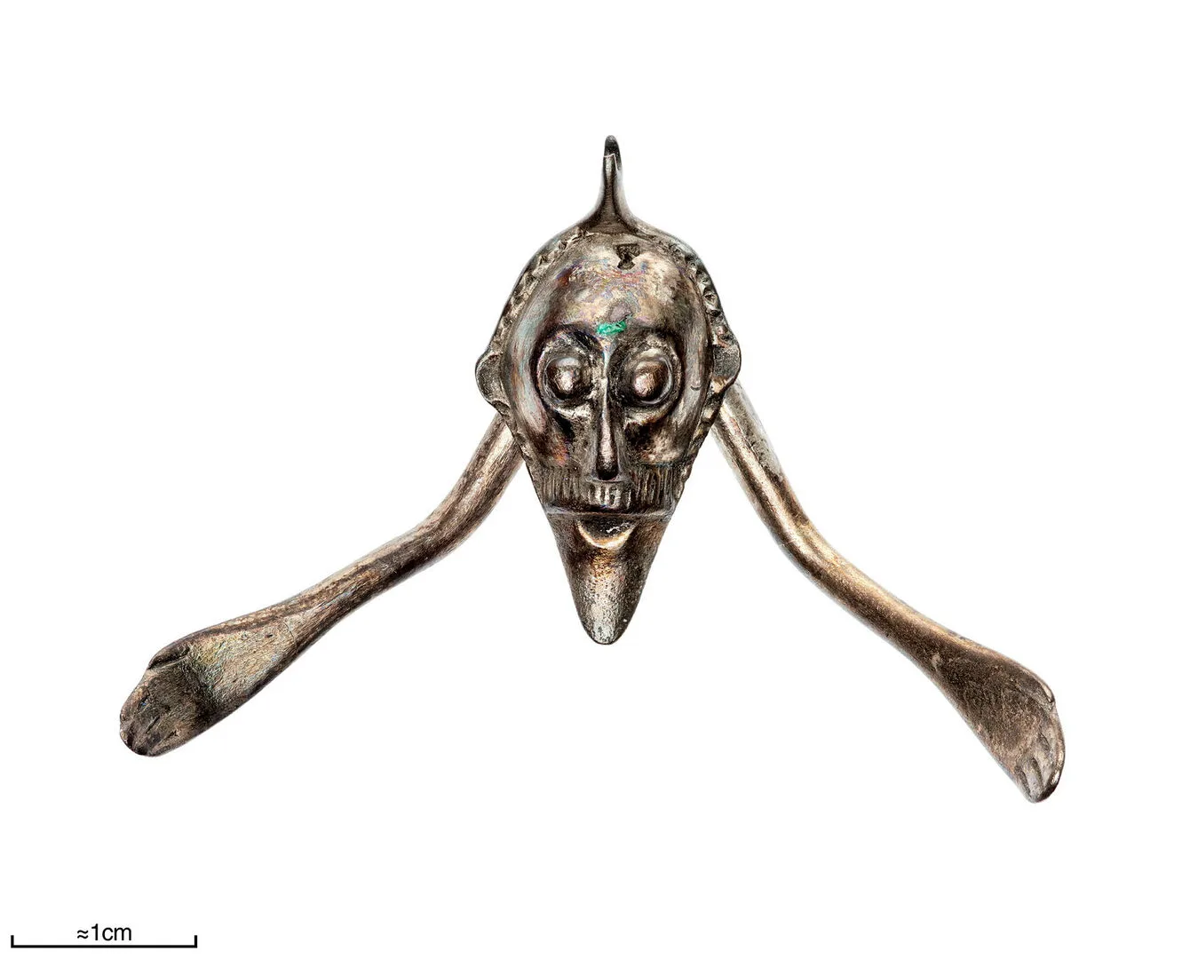 Silver figurine of an elongated head.
