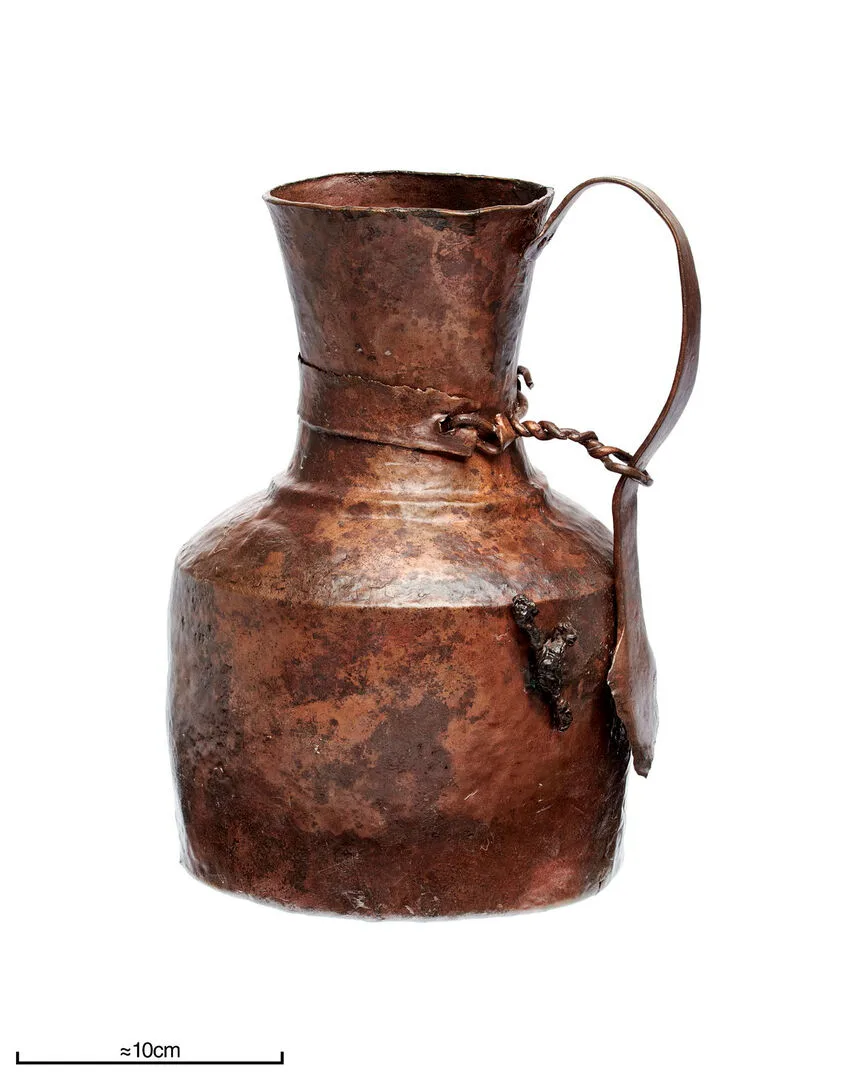 Copper jug with large base and trumpet-shaped funnel.