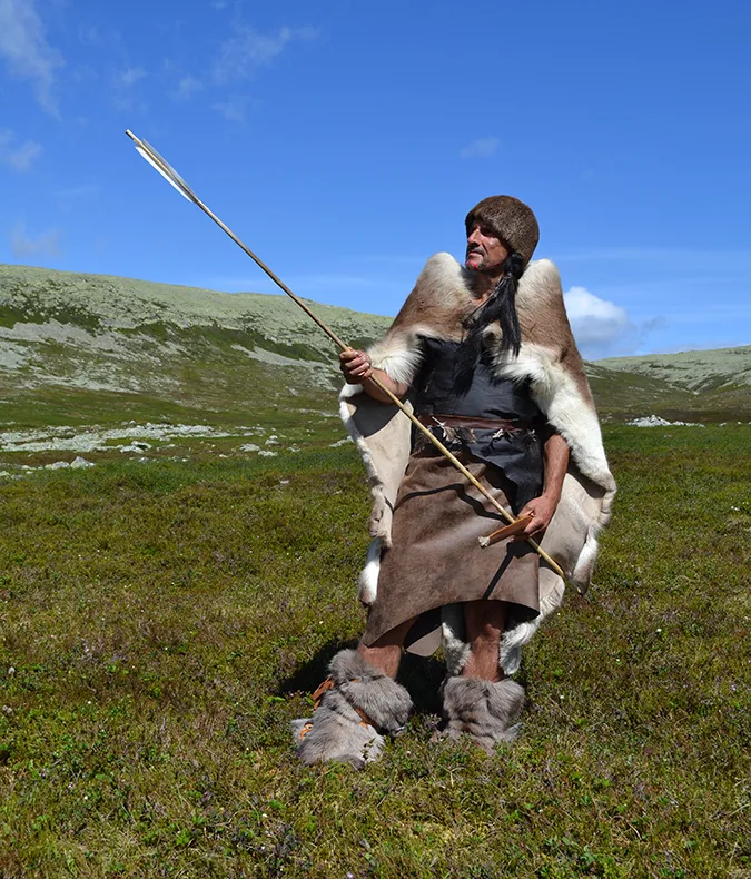 Person in fur and leather with a spear