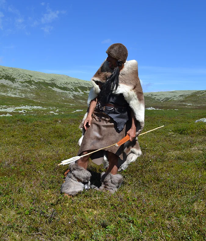Person dressed in leather holding a spear
