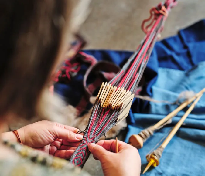 Person doing handicrafts with colorful yarn