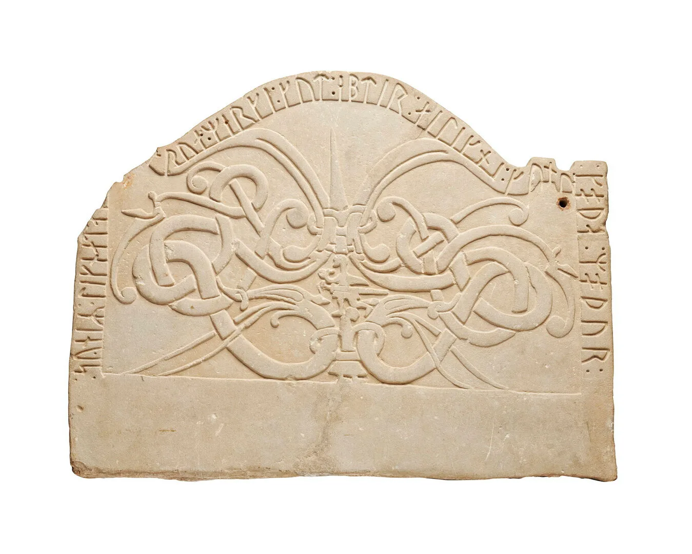 A light yellow stone with intertwining decoration and a rune text.