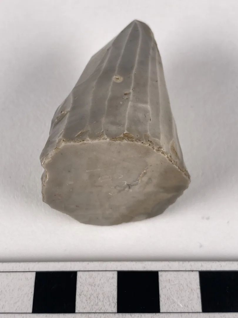 Stone piece with a pointed top and flat bottom