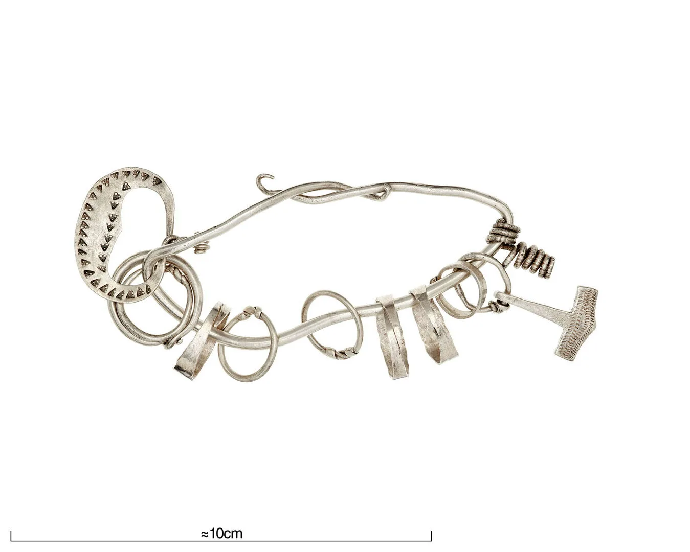 A silver ring with attached pendants; eight smaller rings, two unidentified shapes and one Thor's hammer.