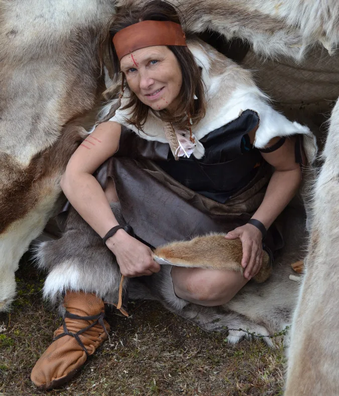 Person in fur and leather inside a fur tent
