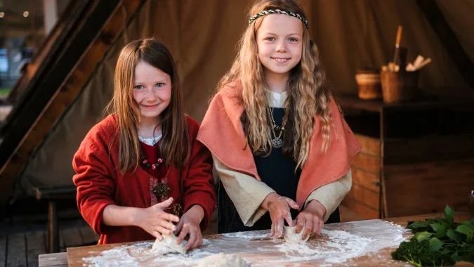 Children baking in Viking Age clothes