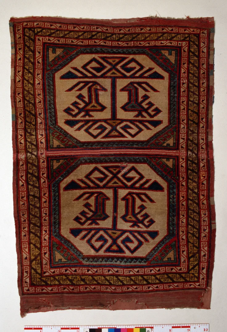 A carpet with red, black and yellow pattern. 