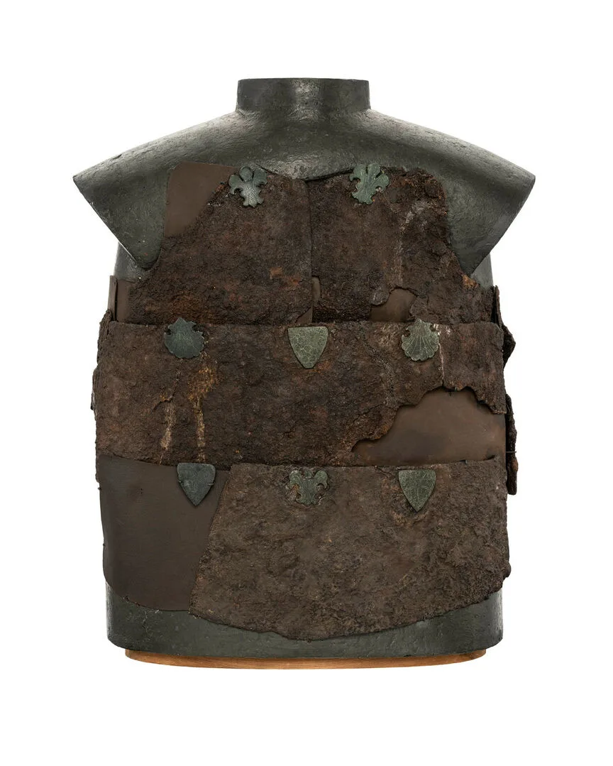 Rusty cuirass with emblems.