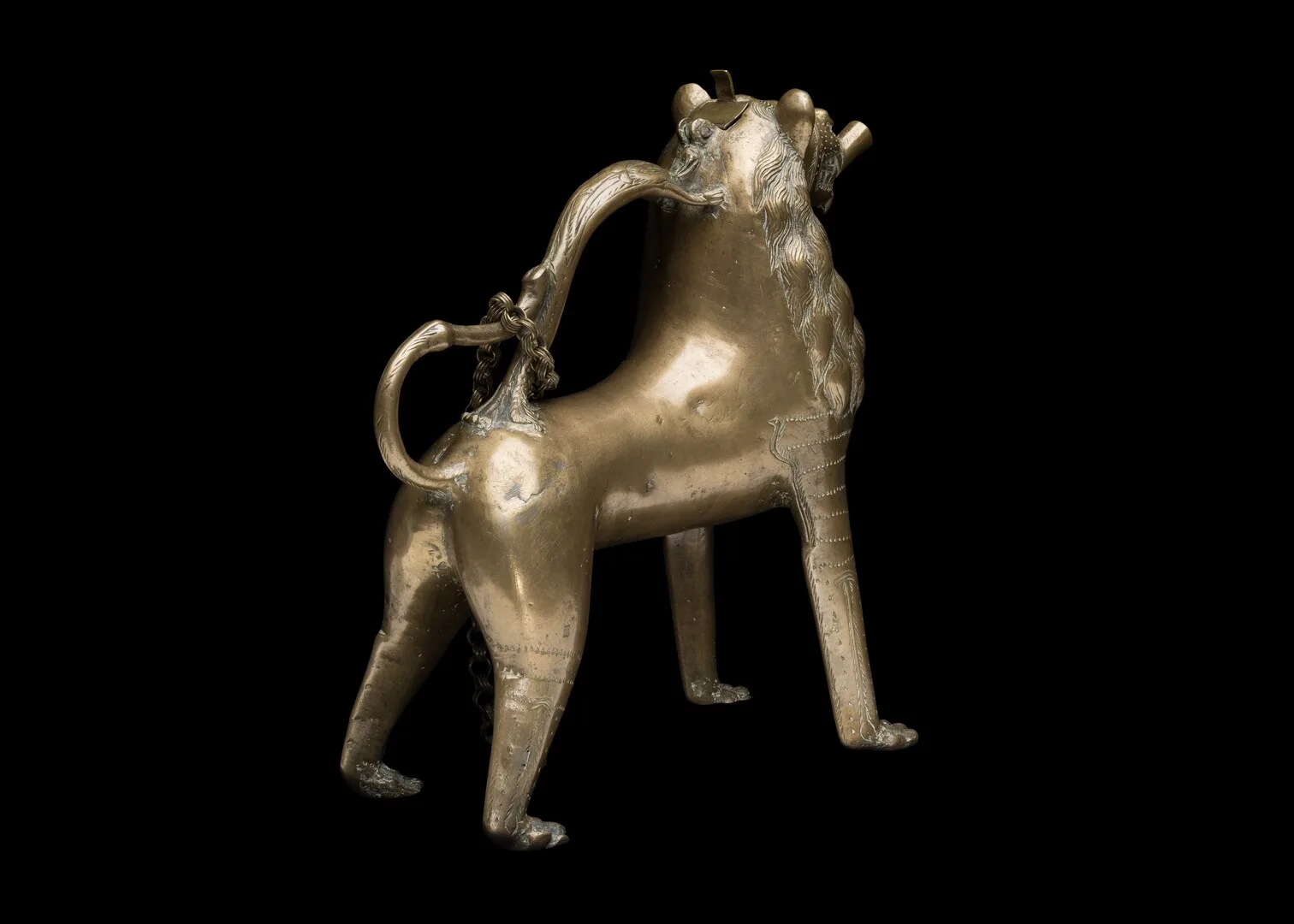 Ett hundliknande djur i metall med svansen som handtag