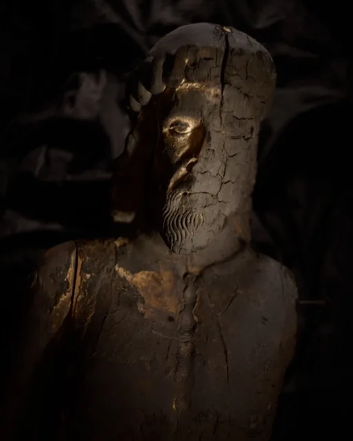 Wooden sculpture with burnt face