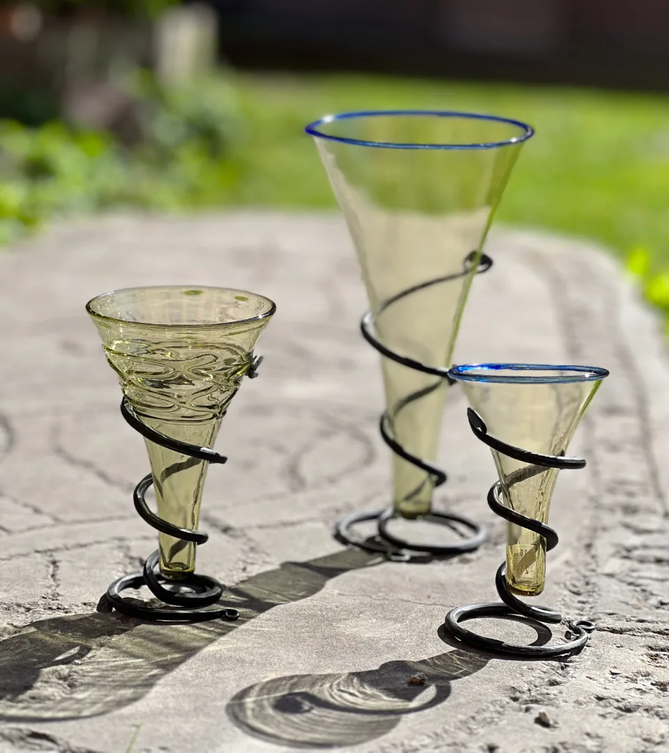 A black soap surrounded by trees and moss.