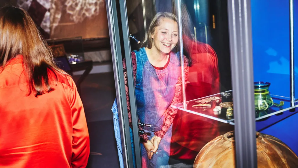 A visitor looks in a display case