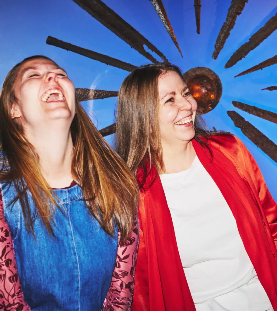 Visitors smile in front of swords